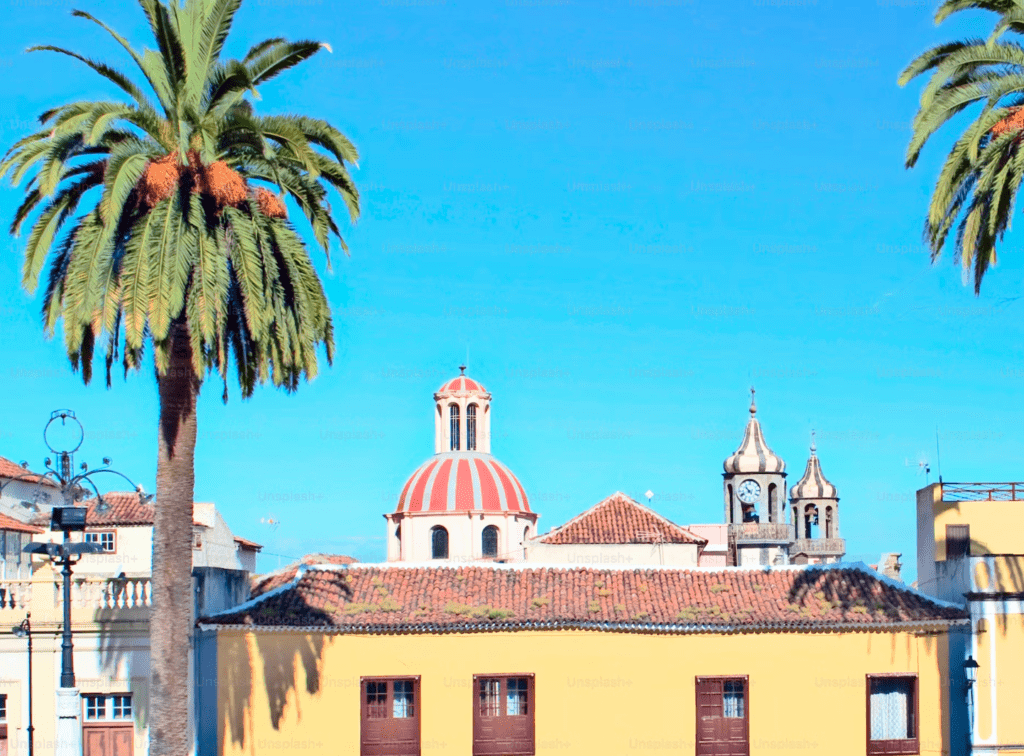 palm trees and old buildings in san cristobal, galapagos